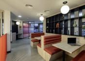 Thumbnail 5 of 8 - a seating area with a laptop computer on a table