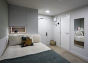 Thumbnail 2 of 8 - a small bedroom with a bed and a mirror