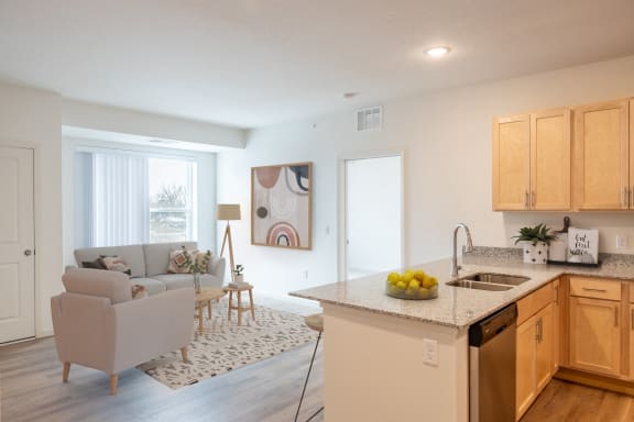 an open kitchen and living room with a couch and a table
