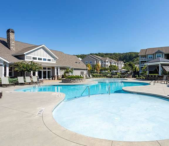 an apartment building with a pond in front of it  at Lullwater at Big Ridge, Tennessee, 37343