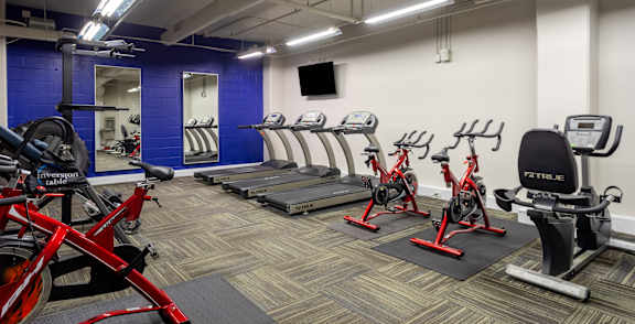 a gym with cardio bikes and other exercise equipment