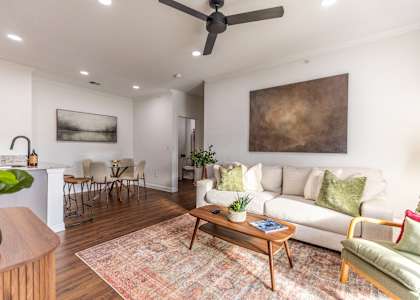 A living room with a couch, chairs, and a coffee table.