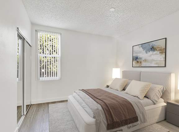 A bedroom with a bed, nightstand, and a painting on the wall.
