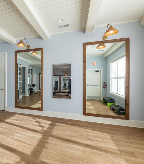 a living room with a large tv on the wall