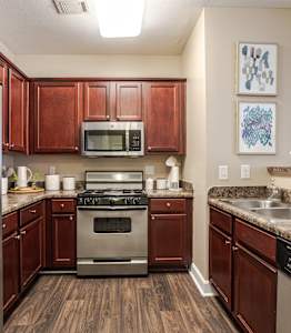 a kitchen with stainless steel appliances and granite counter tops