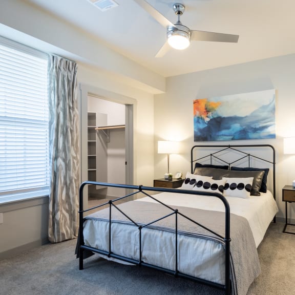 a bedroom with a bed and a ceiling fan