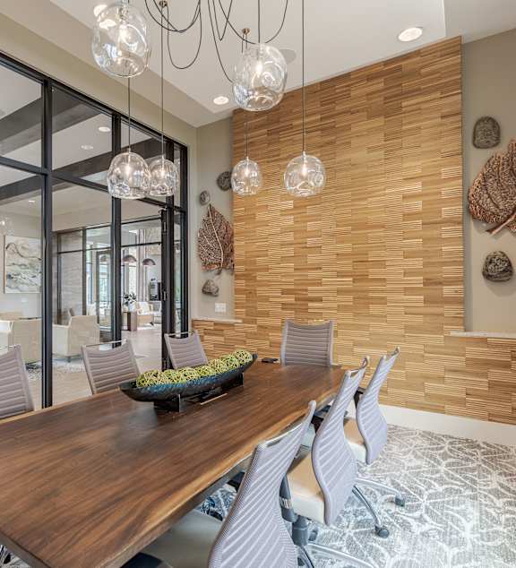 A modern dining room with a wooden table and chairs.