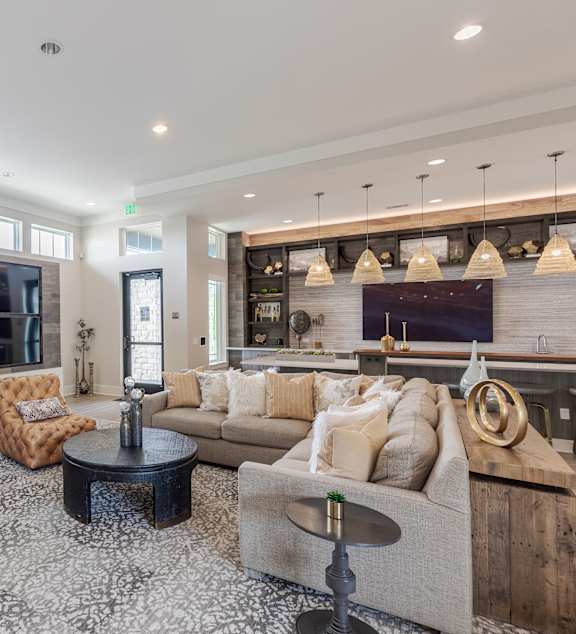 A living room with a couch, two chairs, and a coffee table.