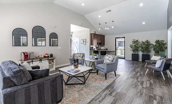 a living room with couches and chairs and a table