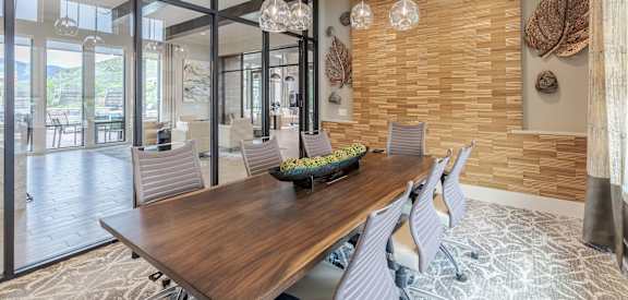 A modern dining room with a wooden table and chairs.