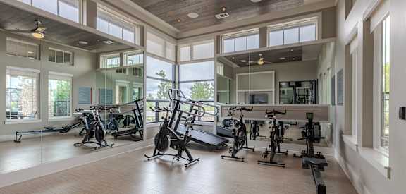 A spacious gym with a variety of exercise equipment.