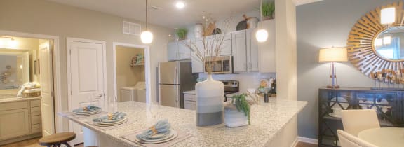 a kitchen with a granite counter top and a dining area