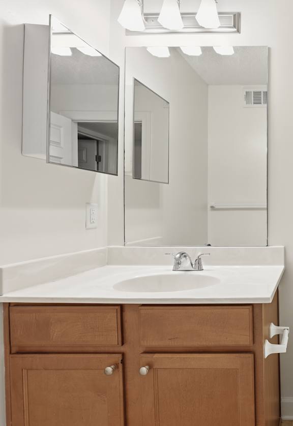 A white toilet sits next to a sink in a bathroom.