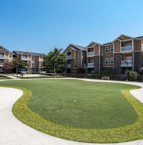 an oval lawn in front of an apartment building