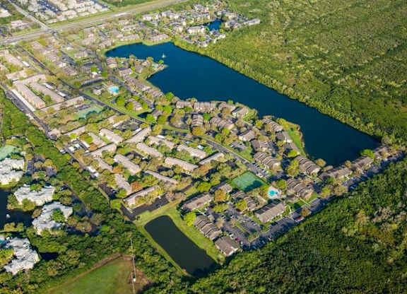 This aerial shot shows our gated community, alongside the 15 acre lake, which includes three pools, and sports courts.