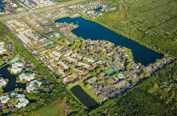 This aerial shot shows our gated community, alongside the 15 acre lake, which includes three pools, and sports courts.
