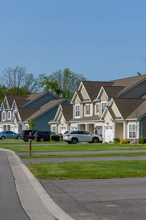 a house on the side of a street with trees
