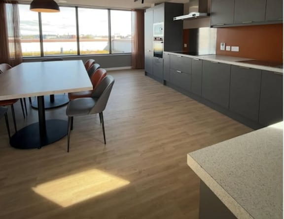 A modern kitchen with a table and chairs.