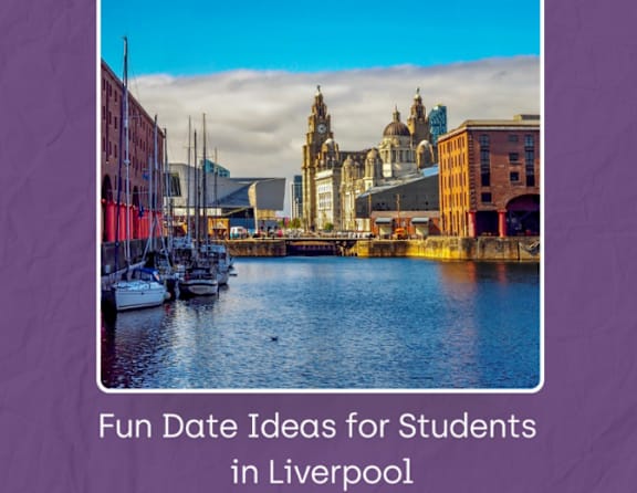 A serene waterfront scene in Liverpool with boats docked and a historic building in the background.