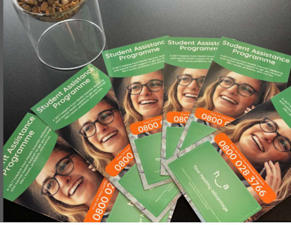 A stack of business cards for a Student Assistance Programme.