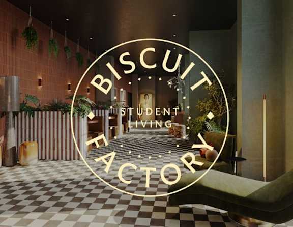 A modern interior space with a checkered floor and a large circular logo that reads "Biscuit Factory".
