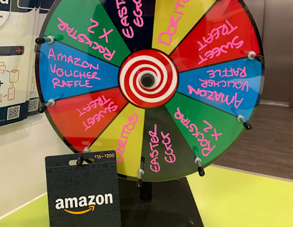 A wheel with the words Amazon Voucher Raffle written on it.