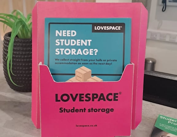 A pink box with the words "LOVESPACE Student storage" on it.