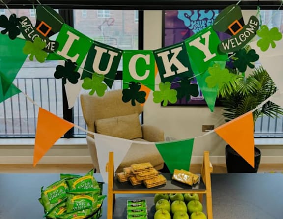 A table with a banner that says LUCKY and some snacks on it.