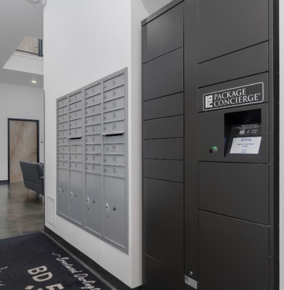 A black door with a sign that says Package Concierge.