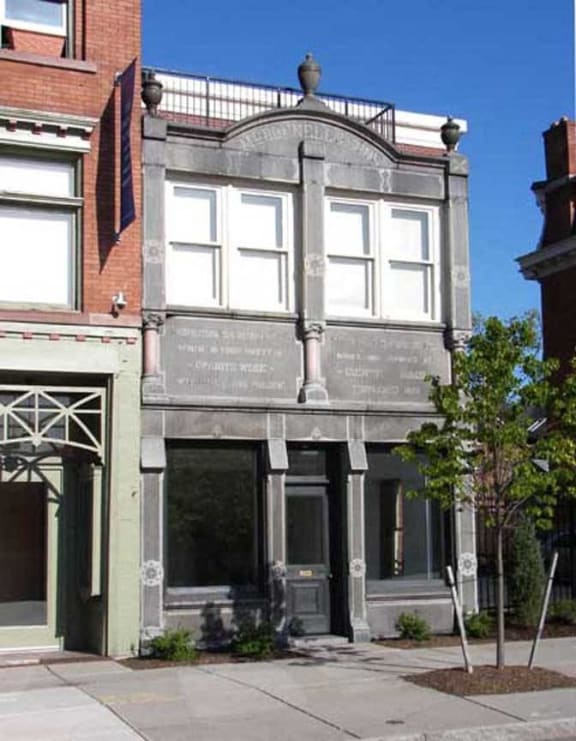 the facade of a building with a tree in front of it at The Granite Works Apartments , Buffalo, 14202