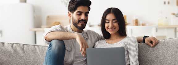 Couple on couch looking at computer_wide