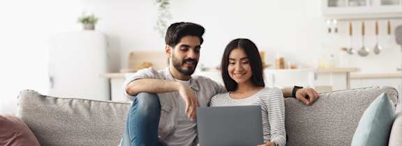 Young couple on couch with computer