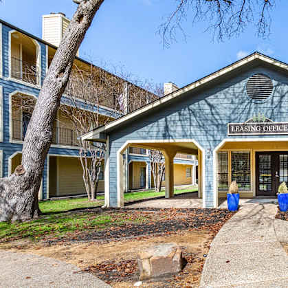 A blue building with the words "Leasing Entrance" on it.