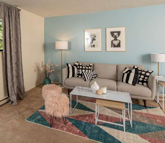 A living room with a couch, a chair, and a coffee table.