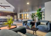 Thumbnail 4 of 5 - a living room with couches and chairs and a kitchen at Proximity at ODU, Norfolk, Virginia