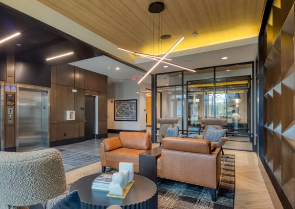 a lobby with couches and chairs and a table at Aura Stonebridge, Richmond Virginia
