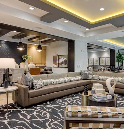 a large living room with couches and tables at Aura Stonebridge, Richmond Virginia