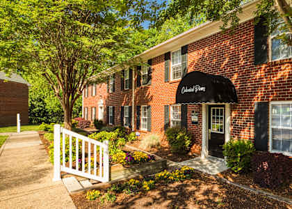 a red brick building with a black awning