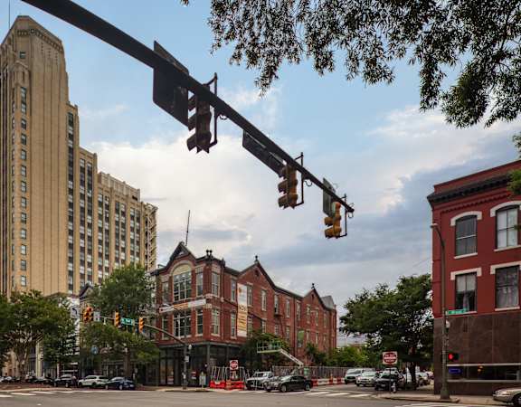 a view of a city street with a tall building in the background