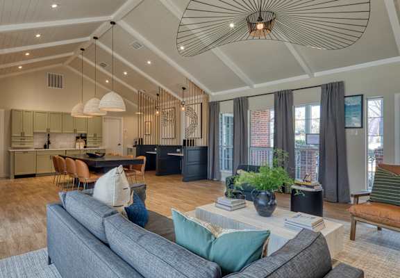 an open concept living room and kitchen with a vaulted ceiling at The Crest on Hampton Hollow, Silver Spring, Maryland