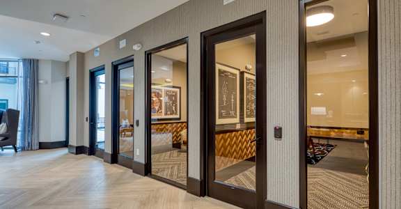 a row of glass doors in a hallway of a building at Aura Stonebridge, Richmond Virginia, 23225