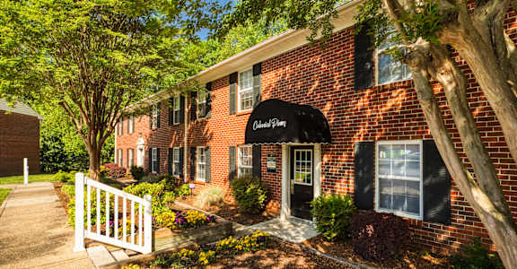 a red brick building with a black awning