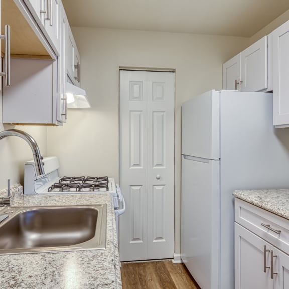 a kitchen with wooden cabinets and a white refrigerator at Gates of West Bay, Norfolk, VA