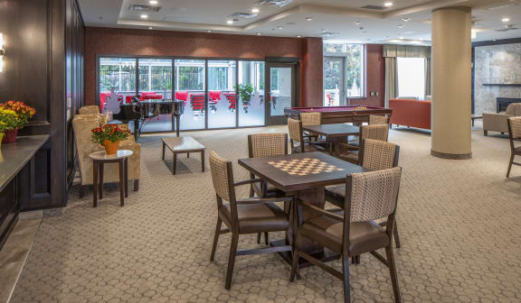 A large room with tables and chairs for games and socializing.