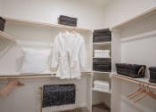 Thumbnail 13 of 19 - a spacious walk in closet with open shelving