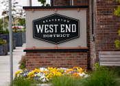 Thumbnail 1 of 14 - a sign on the side of a building that says west end district