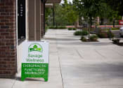 Thumbnail 11 of 14 - a sign outside a building that says savage wellness chiropractic functional neurology