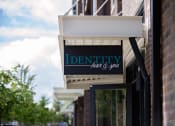 Thumbnail 12 of 14 - a sign on the front of a building that reads identity hair and spa