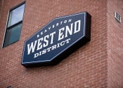 Thumbnail 14 of 14 - a sign on a building that says west end district