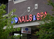Thumbnail 9 of 14 - a sign for nails & spa on the side of a building